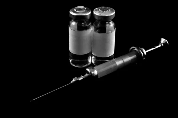 Syringe and medicaments on a black background — Stock Photo, Image