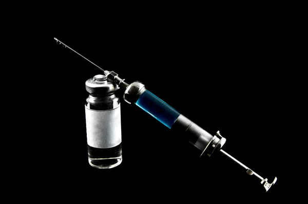 Syringe and medicaments on a black background — Stock Photo, Image