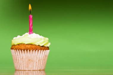 Small green cake with a single candle clipart