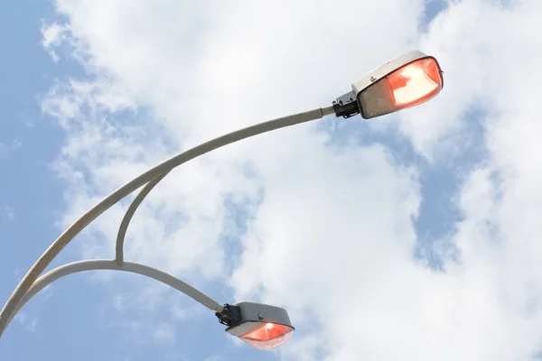 Сияющая уличная лампа над голубым небом — стоковое фото