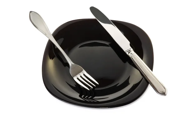 Placa negra con tenedor y cuchillo — Foto de Stock