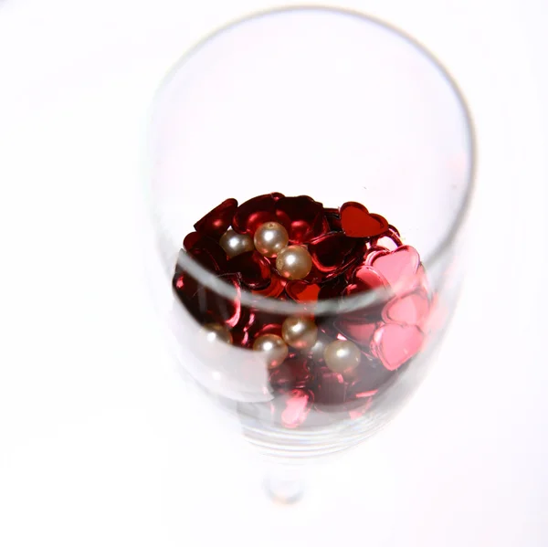 Confetti and pearls in a glass — Stock Photo, Image