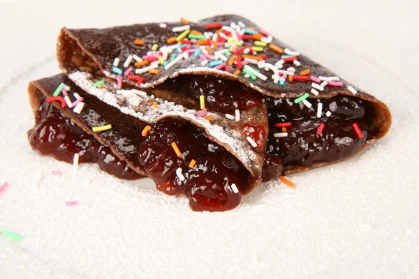 Chocolate pancake stuffed with jam — Stock Photo, Image