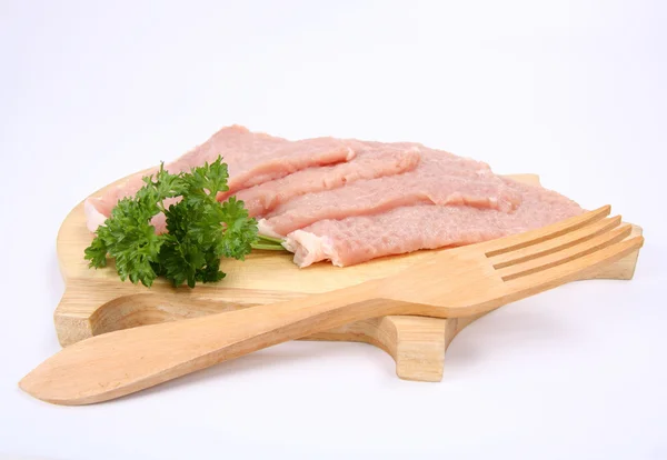 Raw tenderized pork chops and wooden fork — Stock Photo, Image