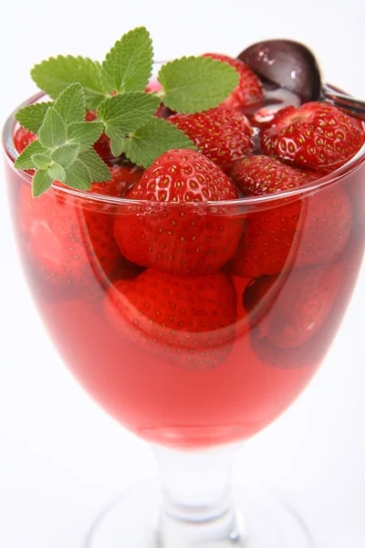 Jelly with strawberries decorated with a lemon balm twig — Stock Photo, Image
