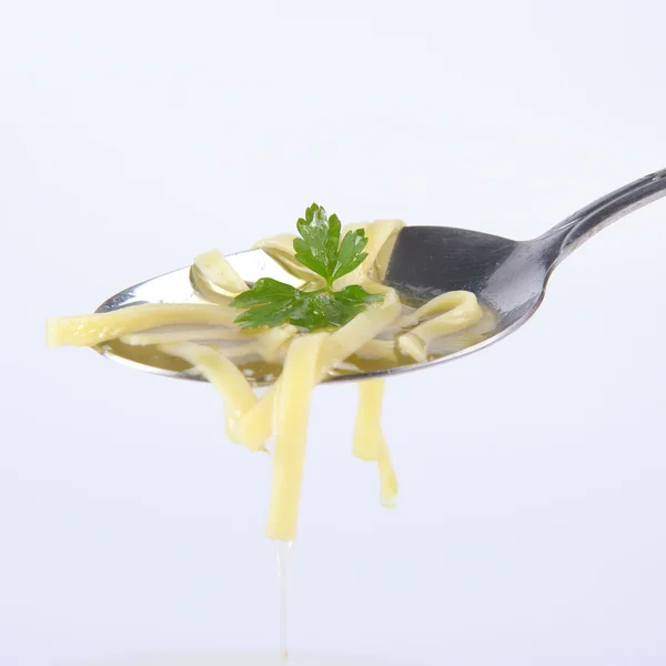 Chicken soup on a spoon — Stock Photo, Image
