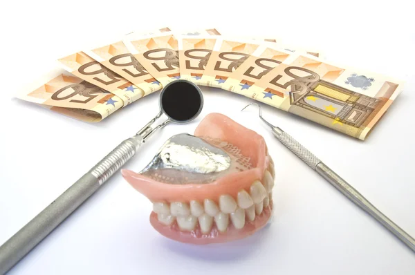 Dinero y prótesis dental Imagen de archivo