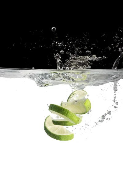 Some limes in water — Stock Photo, Image
