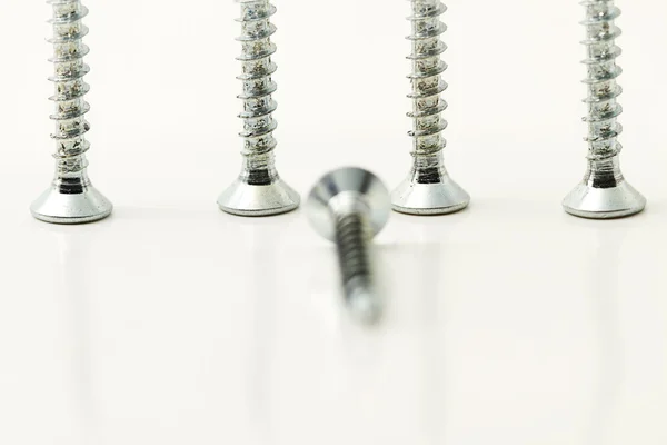 Four screws behind one — Stock Photo, Image