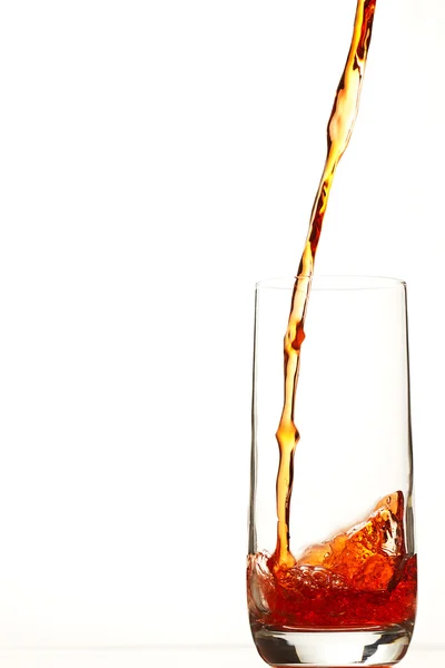 Red liquid pouring in glass — Stock Photo, Image
