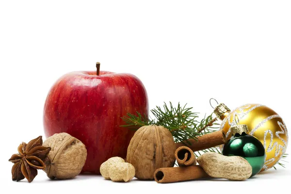 Apple anise nuts christmas balls and a branch — Stock Photo, Image