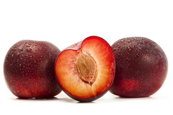 Two and a half wet plums — Stock Photo, Image