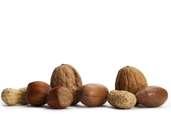 Two of each pecan hazelnuts walnuts and peanuts — Stock Photo, Image