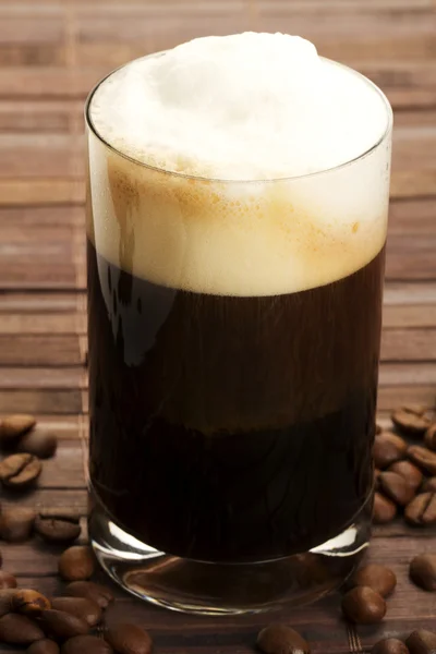 Espresso with milk froth and coffee beans — Stock Photo, Image