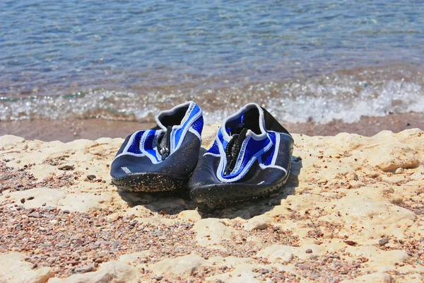 stock image Swimming shoes on white stone