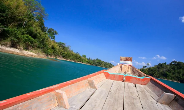 stock image Cruising with wooden boat in clear blue