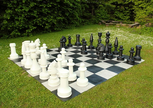 Big outdoor chess in green lawn — Stock Photo, Image