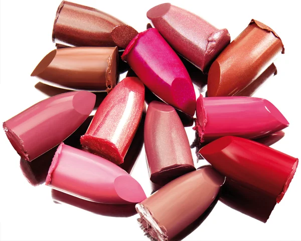Multi-coloured scraps of lipstick on a mirror with reflexion — Stock Photo, Image