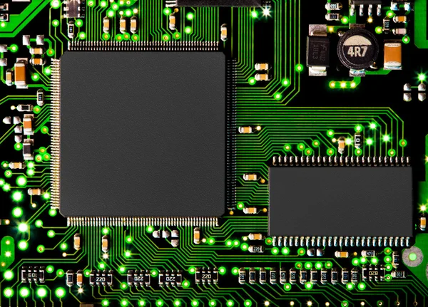 Close up of computer circuit board in green with transistors and — Stock Photo, Image