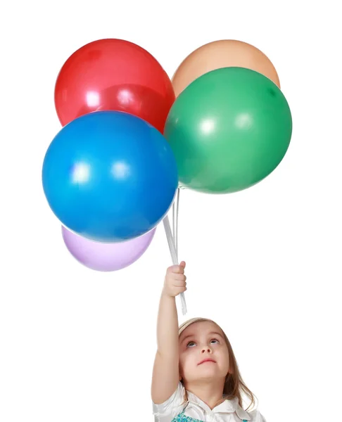 Chica sosteniendo un montón de globos — Foto de Stock