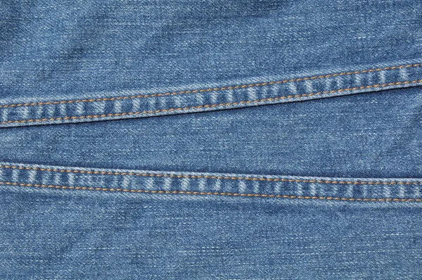 Текстура на синем джинсе — стоковое фото