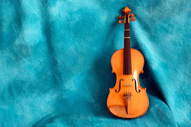 Full violin aganst blue backdrop clipart