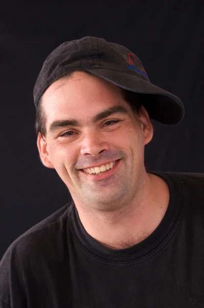 Man smiling with sideways cap