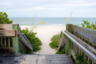 Wooden walkway leading to beach clipart