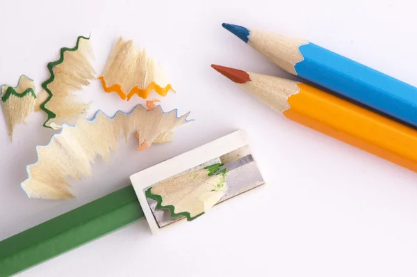 Color pencils and sharpener shaving — Stock Photo, Image