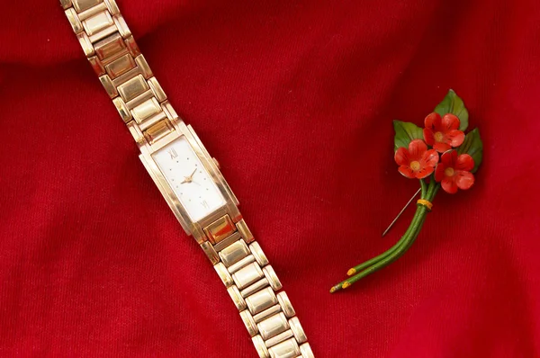 Womens Golden Watch sobre fundo vermelho — Fotografia de Stock