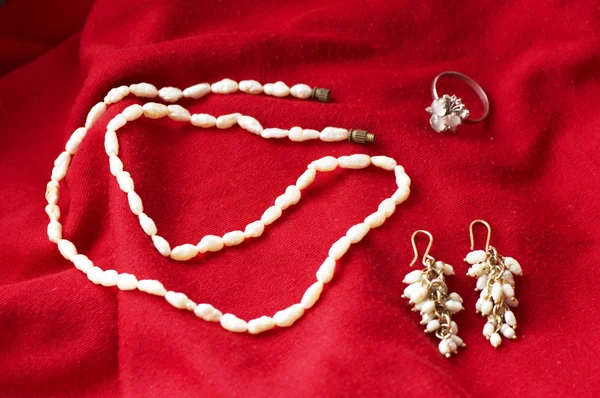 Necklace and jewelry on luxury satin background — Stock Photo, Image