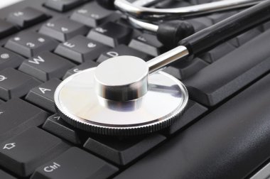 Stethoscope on computer keyboard clipart