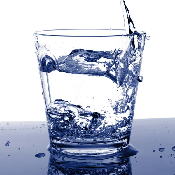 Filling a glass with water — Stock Photo, Image