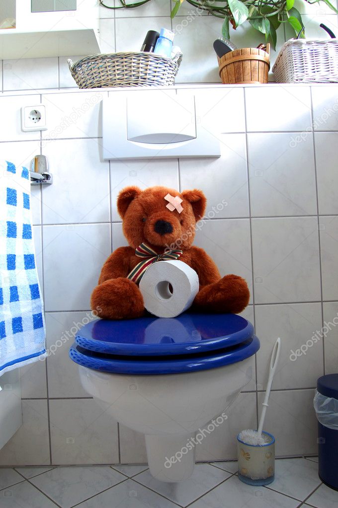 Toy teddy bear on wc toilet