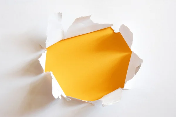 Buraco amarelo em papel — Fotografia de Stock
