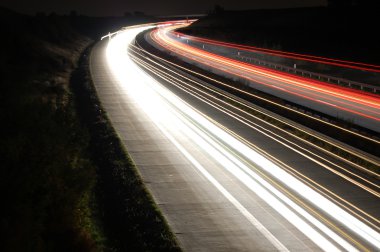 Highway at night with traffic clipart