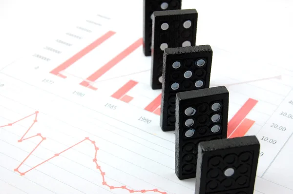Riskantní domino nad grafem finanční podnikání — Stock fotografie
