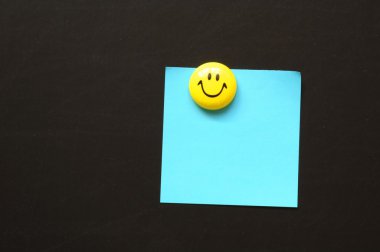 Smiley and paper with copyspace clipart