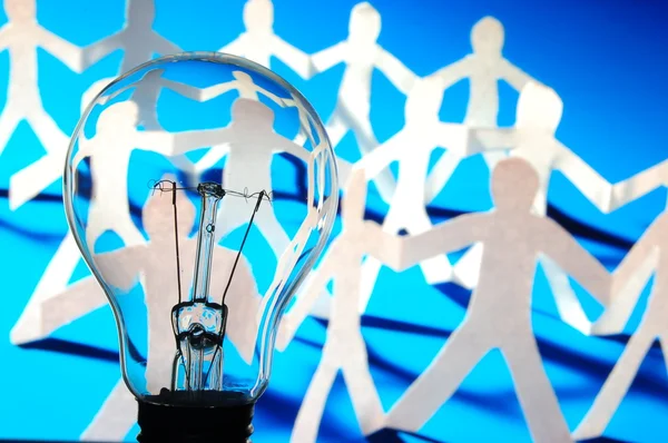 Bulb and team of paper man — Stock Photo, Image