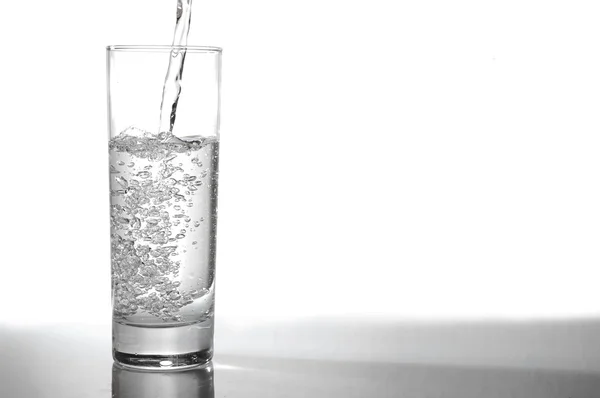 Glass of water pouring — Stock Photo, Image