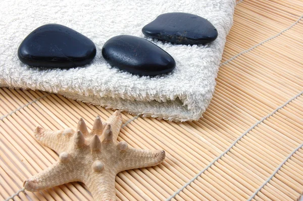 Foldet bílé vany ručník a zen stones — Stock fotografie