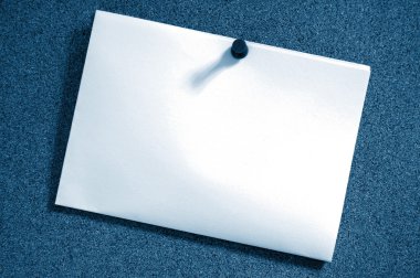 Blank sheet of paper on bulletin board