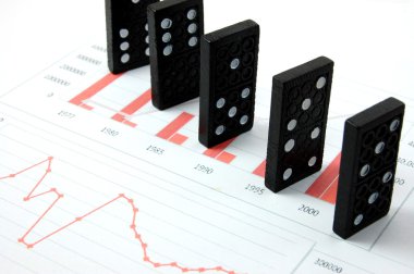 Risky domino over a financial business chart clipart