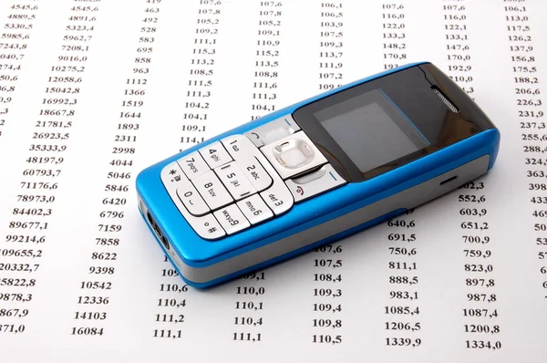 Cell phone over business chart — Stock Photo, Image