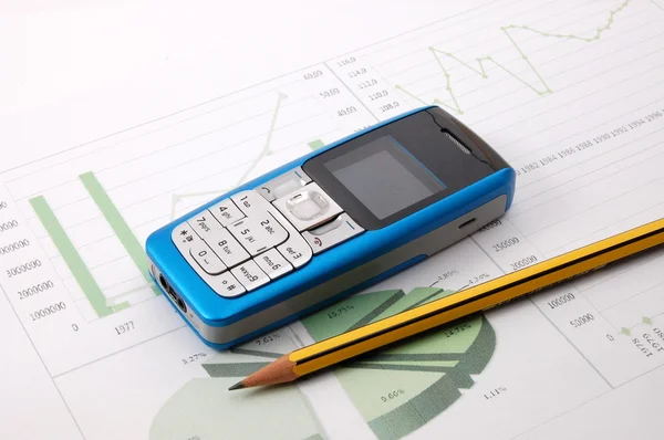 Cell phone over business chart — Stock Photo, Image