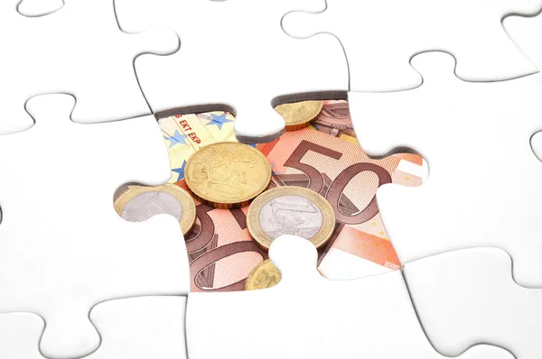 Puzzle a peníze — Stock fotografie