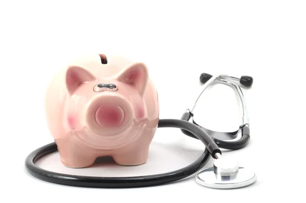 Stock image Stethoscope and piggy bank