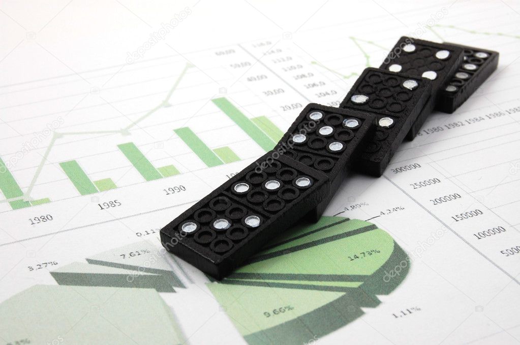 Risky domino over a financial business chart