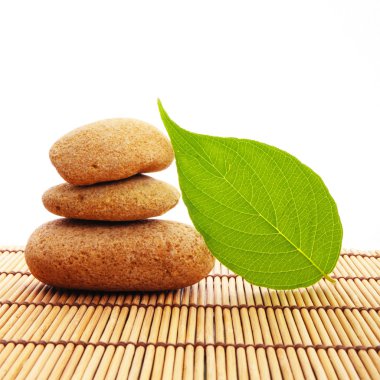 Zen stack or tower with green summer leaf showing spa or wellness clipart