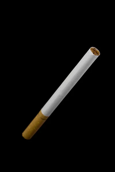 Cigarette isolated on black — Stock Photo, Image